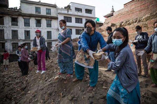 Women leader in Nepal clear rubble.