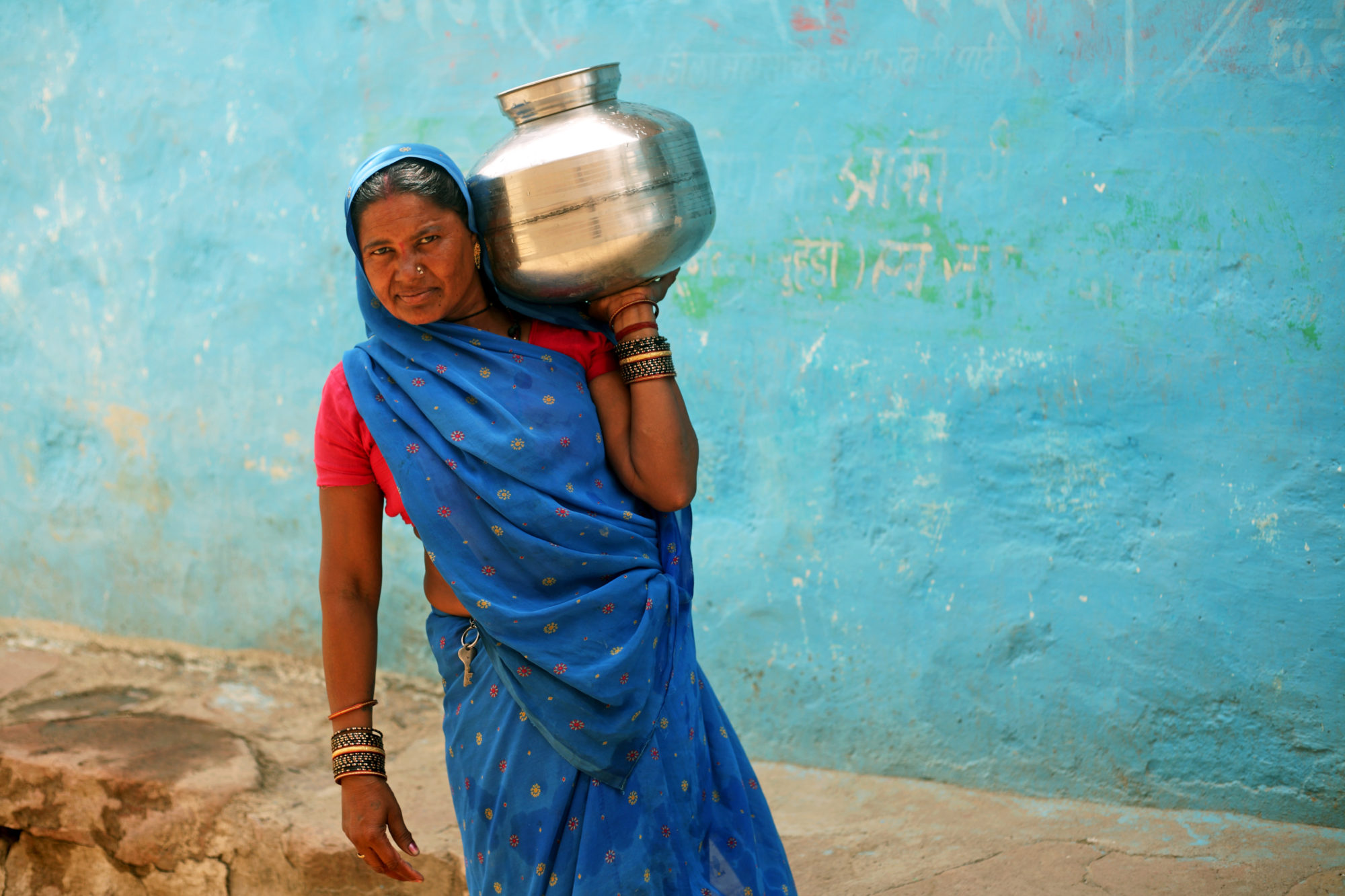 Mana Devi carries drinking water back to her family in Balchour village, India. Photo by Srikanth Kolari/ActionAid.