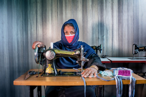 Anowara making masks at her sewing machine