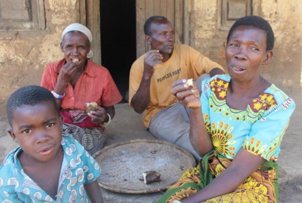 Nkhoma with her husband, mother and son, eating their one meal of the day.