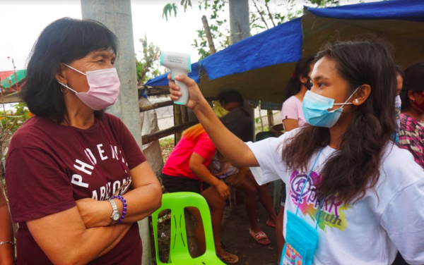 Youth volunteers perform COVID-19 temperature checks, The Philippines 2020.
